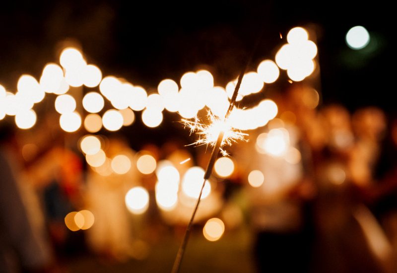 sparklers at the wedding of the newlyweds in the hands of joyful guests